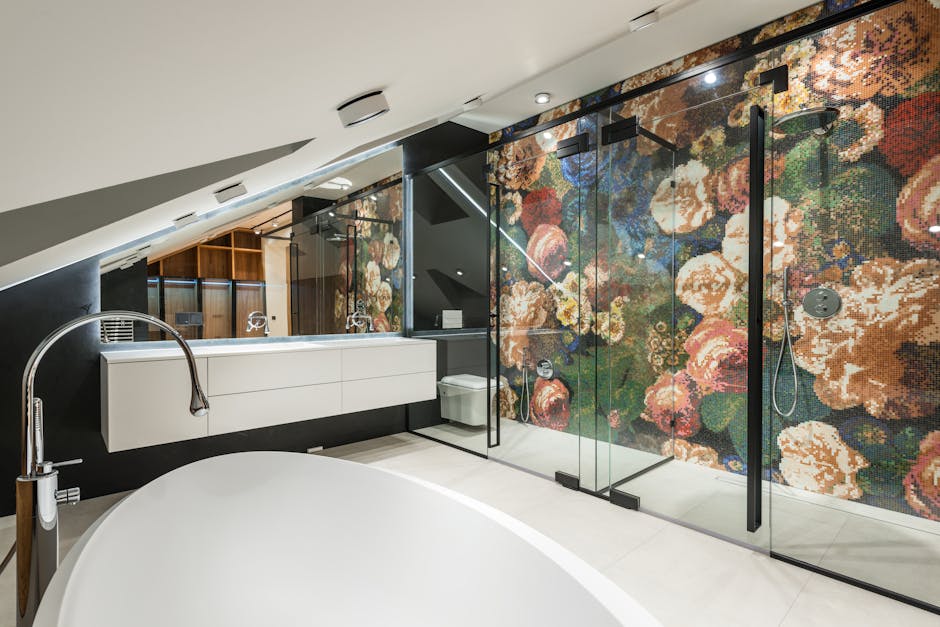 Elegant bathroom featuring a freestanding bathtub and floral mosaic wall in a modern interior.