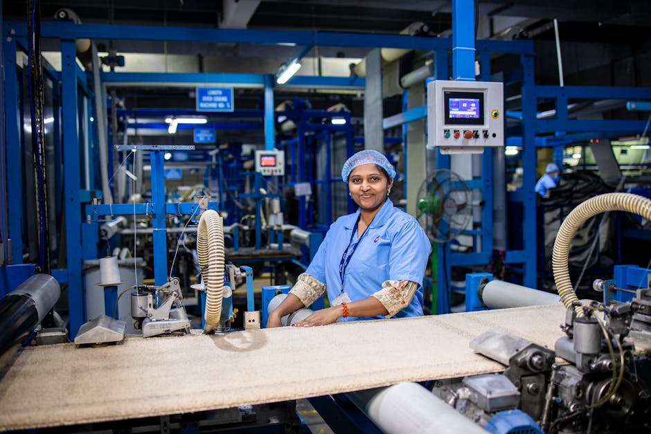 Smiling female worker in a modern textile factory, showcasing the industrial workspace.