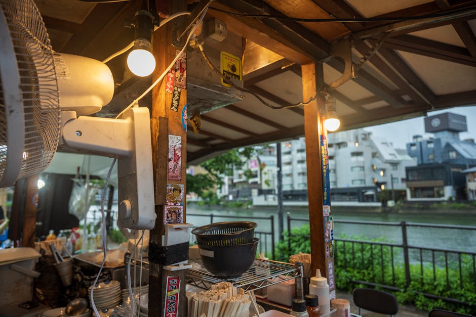 Cozy riverside street food stall with urban backdrop and culinary details, perfect for nightlife themes.