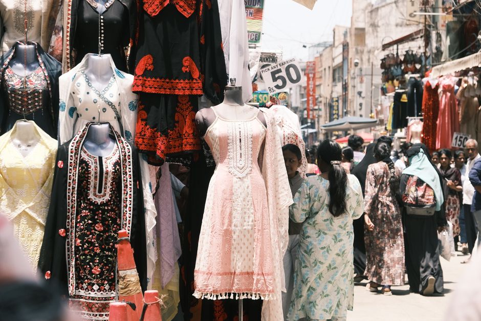 Colorful street market scene in Bengaluru featuring ethnic garments and bustling crowd, capturing urban life.